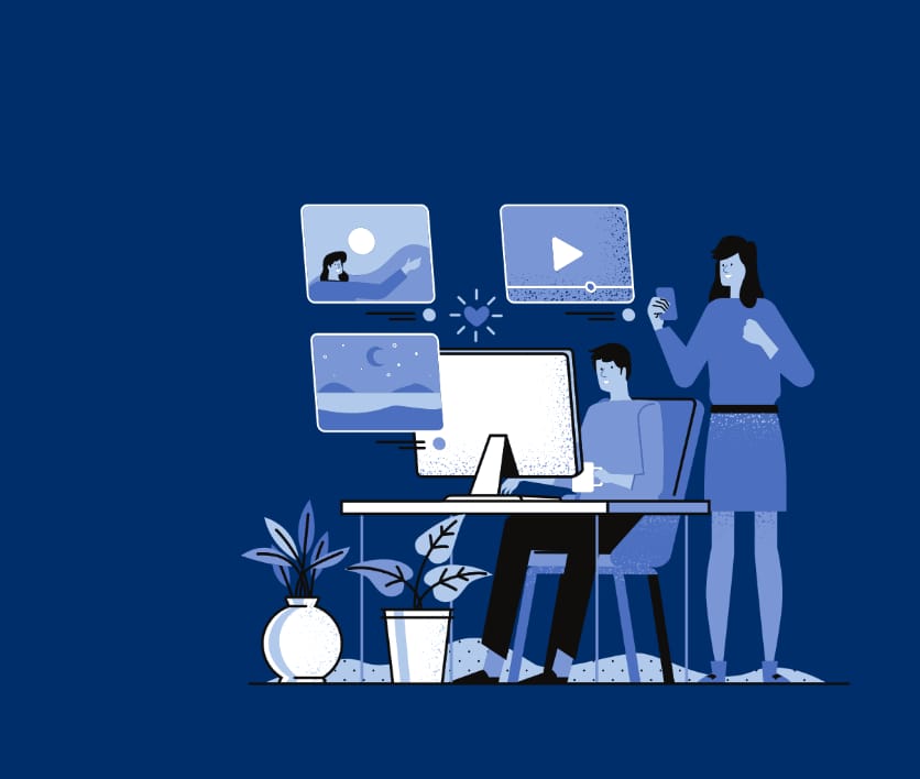  Illustration of two people working on social media content. One person sits at a desk using a computer, while the other stands holding a phone. Floating icons above the desk show images, videos, and engagement symbols. Decorative plants are placed near the desk, all set against a dark blue background.