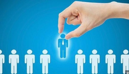 A hand is reaching down to touch a blue human icon that's glowing. The blue icon stands out among a row of white human icons at the bottom of the image. The background is a solid blue color.