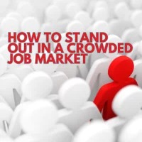 A single red human-shaped figure stands out among many white figures, symbolizing uniqueness in a crowded job market. The text “HOW TO STAND OUT IN A CROWDED JOB MARKET” appears in bold red letters at the top.